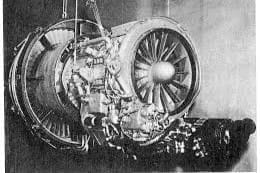 Black and white image of a General Electric CF700 turbofan engine, partially disassembled and suspended for maintenance, showcasing its forward fan and exposed internal components.