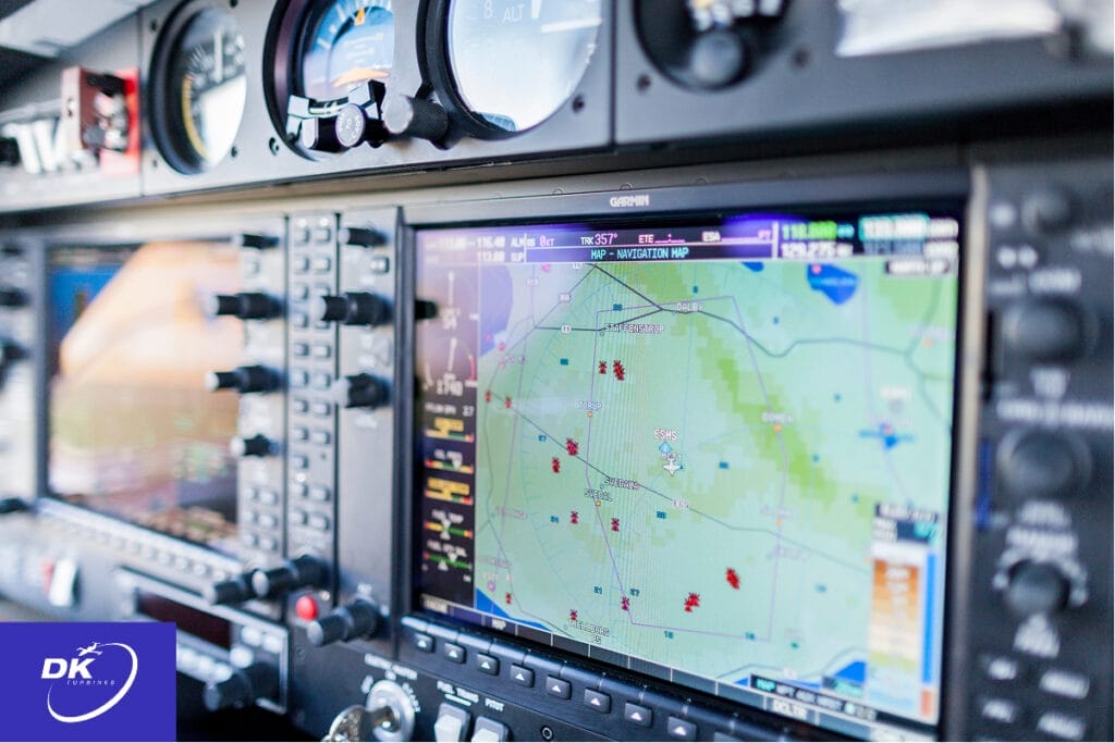 Close-up view of a modern aircraft display showing navigation systems, maps, and instrumentation in a cockpit setting.