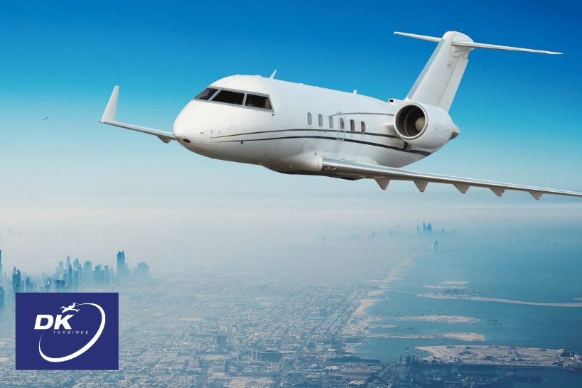 Airplane flying at high altitude above a large city skyline.