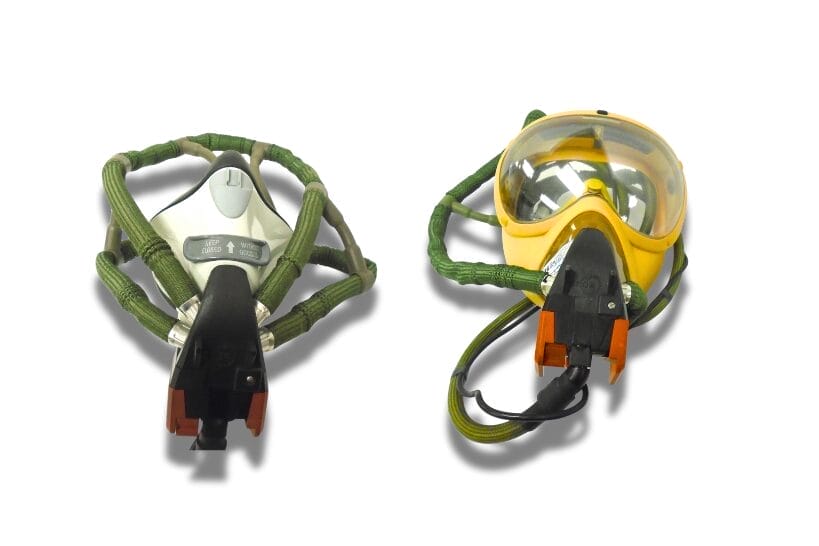 Different types of airplane oxygen masks in yellow and white with green straps